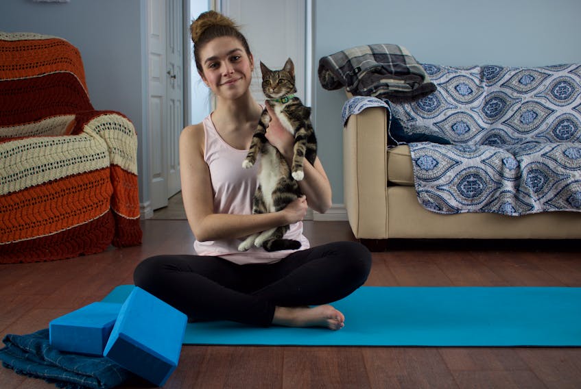 Journalist Millee McKay - pictured with her feline companion Jinx -  shares some of her favourite yoga poses.