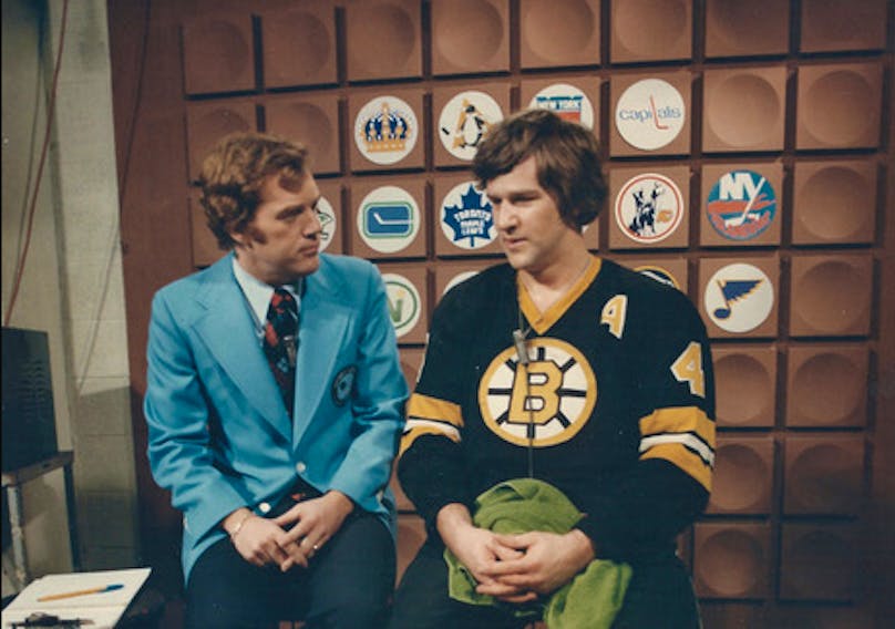Hockey Night In Canada’s Dave Reynolds, left, and former Boston Bruins star Bobby Orr relax prior to a between-periods interview.