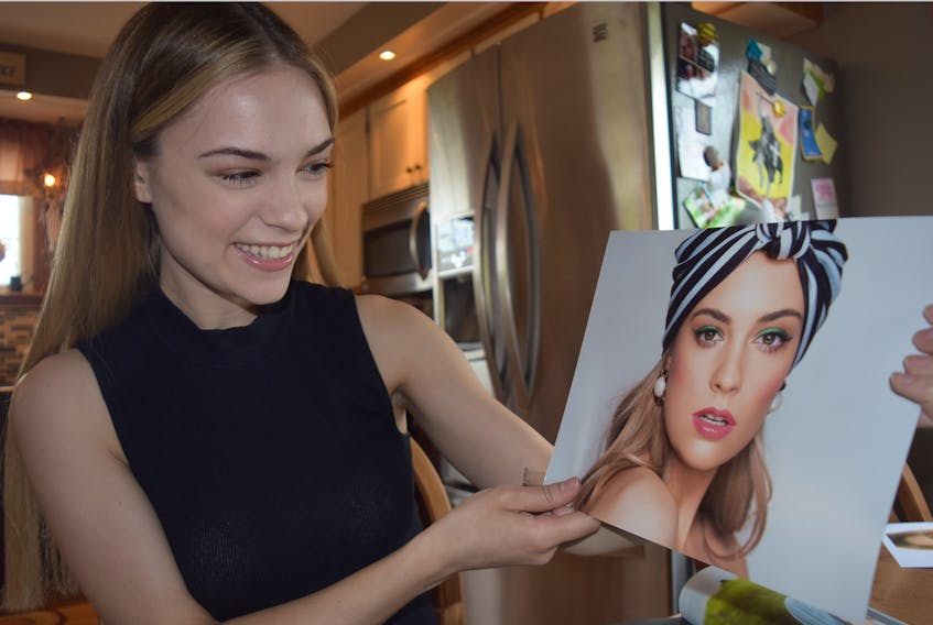 Maggie Sutherland of Central Onslow is all smiles as she shows off the picture that won her an award for best cover photo in her 20-plus age division during a recent modelling show in Toronto.
