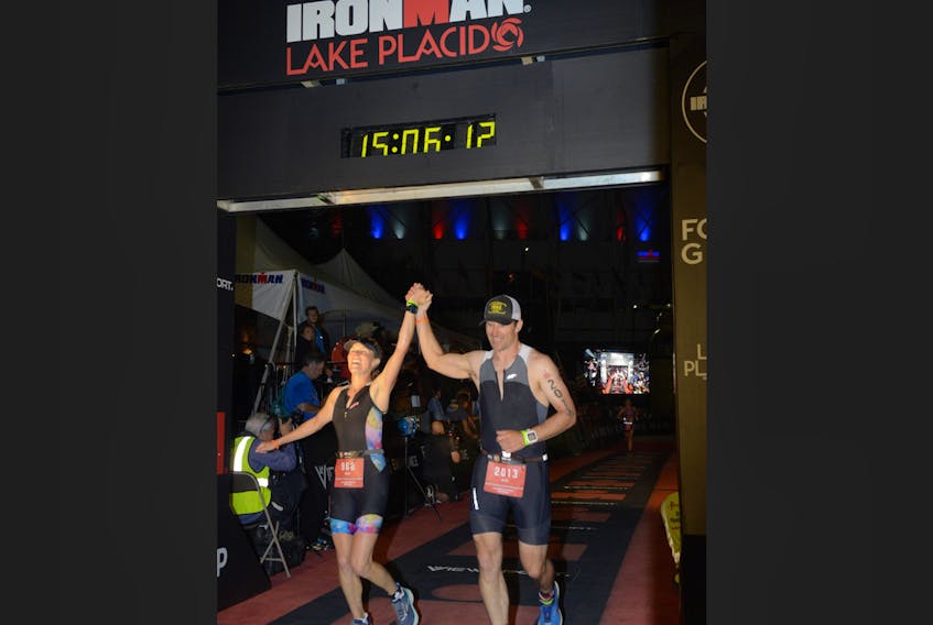 Dara Pelkey-Field and Mike Field cross the finish line together at the Ironman triathlon in Lake Placid.