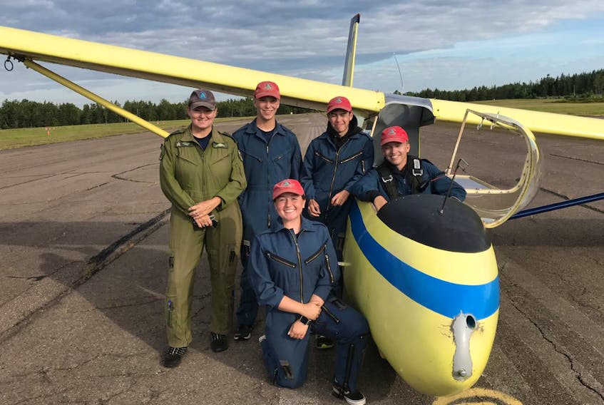 Gliding instructor Shelley Kwik-Mitchell, left, is shown with four students who recently earned their glider pilot licences.