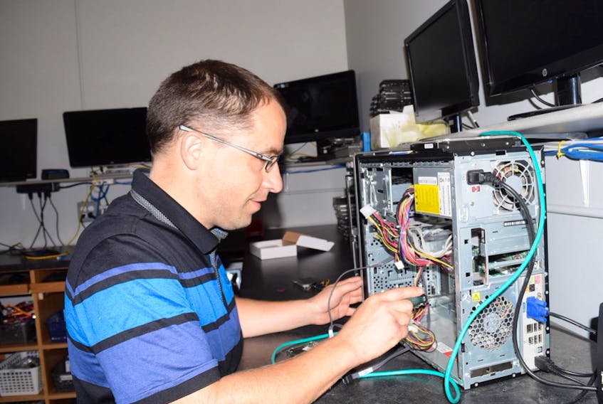 Keith Gillis and his staff regularly dismantle, inspect and repair desktop computer components at their Truro headquarters.