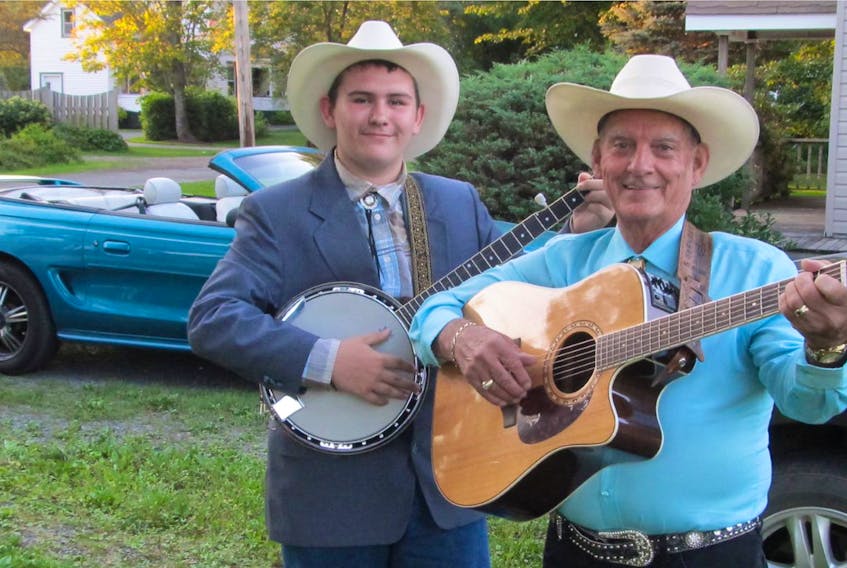 Lance Pratt, banjo player and singer, is shown with his friend and supporter Butch McClellan.