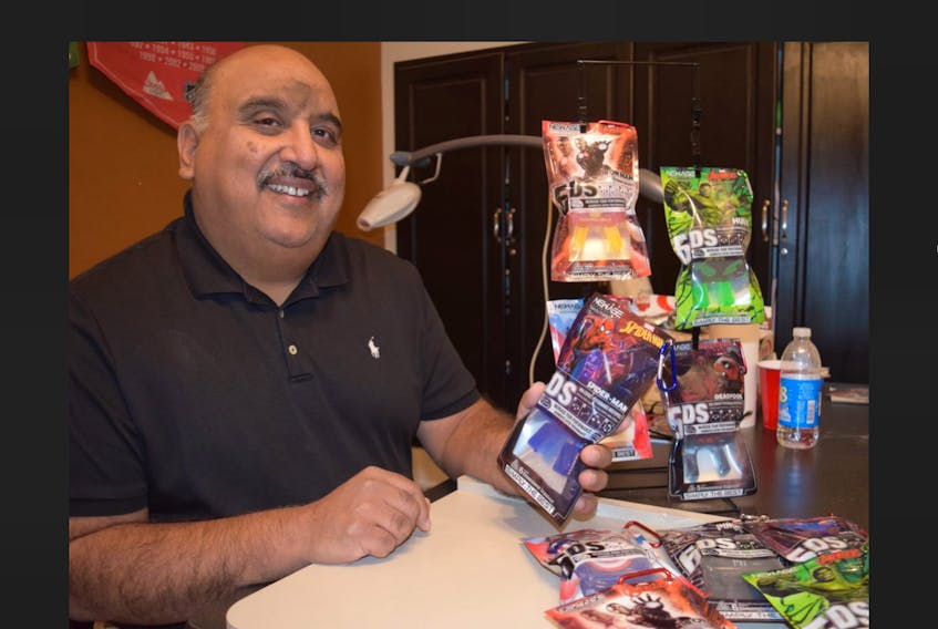 Anil Makkar, a Truro dentist and partner with New Age Performance Mouthware, shows off some of the Marvel Comics superhero mouthpieces that are now available. The company has been endorsed by Marvel for worldwide distribution of its superhero collection.