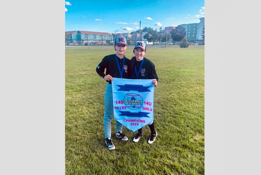 There was plenty of local representation at the recent 2019 Baseball Atlantic 14-years and under girls’ baseball championship earlier this month in Fredericton, N.B. Members of Team NL Black Dedra Lyver, left, and Holly Russell, after the team won the championship banner.