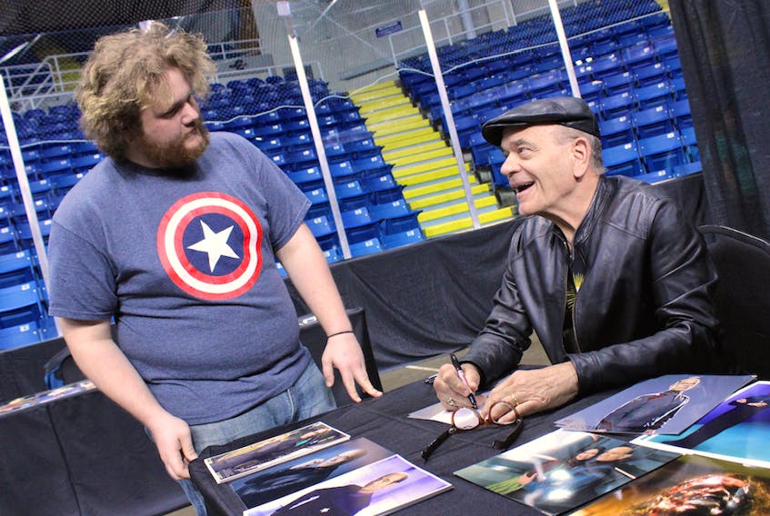 American television actor Robert Picardo, best known as The Doctor on ‘Star Trek: Voyager” and Coach Cutlip on “The Wonder Years,” signs a photograph for Daniel White of North Sydney during CaperCon weekend at Centre 200.