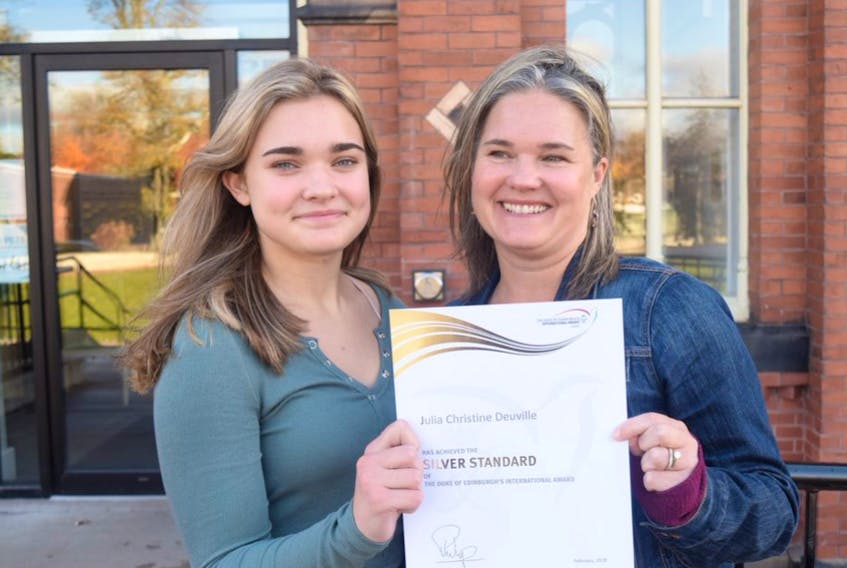It took Julia Deuville, left, nearly two years to earn her silver Duke of Edinburgh award. She's seen here with her mother, Erin.