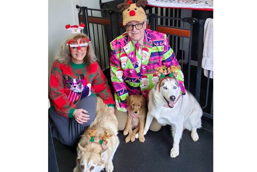 Reta and Marcel Marcotte with their dogs Simone and King. The puppy is Bailey and it was her first day at daycare when the photo was taken