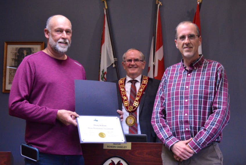Doug Killam, left, public works manager for the Town of Kensington, shows the certificate of appreciation from the town with Kensington Mayor Rowan Caseley and chief administrative officer Geoff Baker. Killam has completed course work with the Environmental Training Institute.