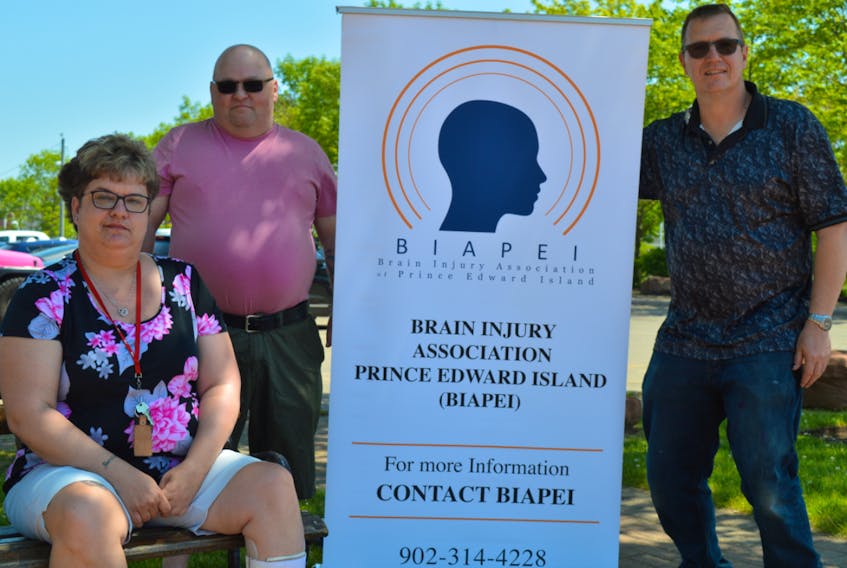 Simon Micklethwaite, right, president of the Brain Injury Association of P.E.I., says the group plans to offer more peer support help and hopes to find locations across the province to meet with clients. He’s pictured with board members, Wendi Plets and Elton Poole.