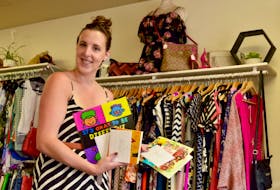 Shawna Perry, owner of Little Black Dress in Summerside, shows some of the books she was able to buy with the proceeds from a recent sidewalk sale. The books have been donated to daycares across the province.