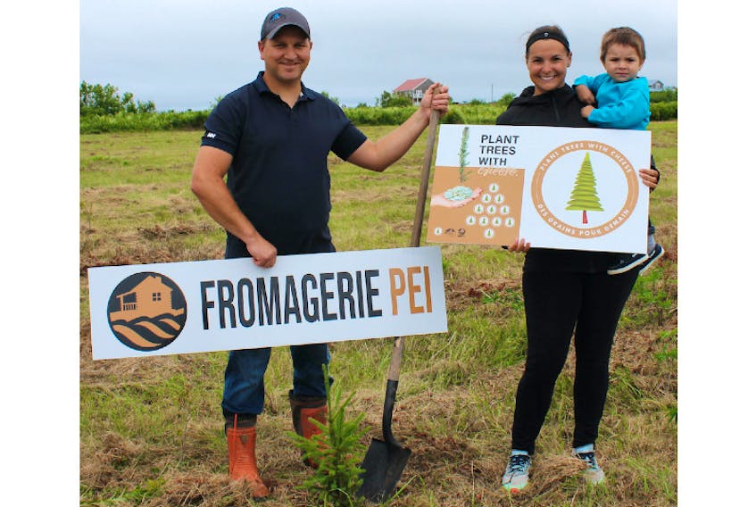 Mathieu Gallant from Fromagerie P.E.I., his two-year-old son, Pascal, and his wife, Josée Boudreau, launch the “Plant Trees with Cheese” initiative which will plant a tree for each case of cheese sold to a restaurant.