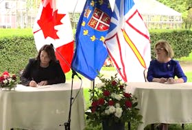 After Premier Andrew Furey took the oath as the minister responsible for intergovernmental affairs, Siobhan Coady (left) became the first announced member of Furey's cabinet, signing on as finance minister and deputy premier.