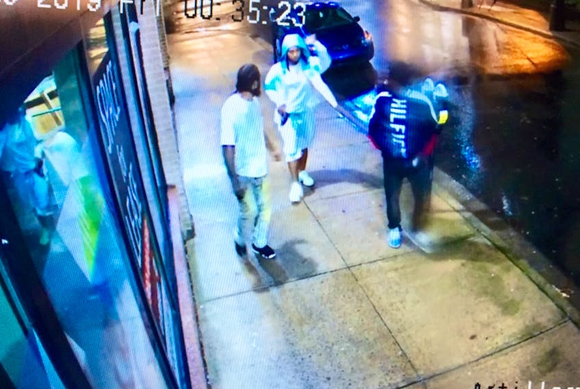 An image from surveillance video shows Demarqus Shane Beals, left, Devonte Denzel McNeil and Jayree Vontaze Downey walking along Artillery Place in Halifax shortly after a shooting on nearby Dresden Row on Aug. 9, 2019.  McNeil is holding a pistol in his right hand.