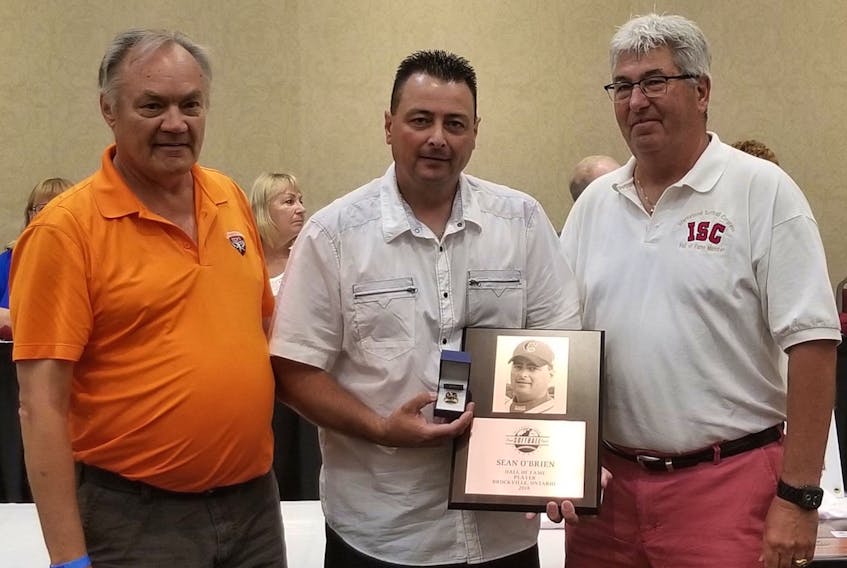 Sean O’Brien (centre), who is originally from St. John’s, but lives in Brockvile, Ont., was inducted into the International Softball Congress Hall of Fame Sunday in Kitchener, Ont.