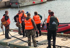 PEI Ground Search and Rescue meet before heading out on water from the wharf in Northport Thursday morning. There is an ongoing search for two teen boys who have been missing since last night after their boat capsized.