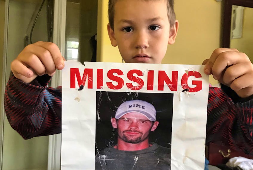 Jeremiah Cooper with a poster asking for help finding his uncle Luke, who went missing in Labrador over a year ago. CONTRIBUTED PHOTO