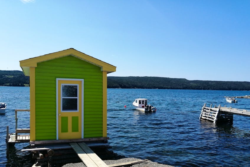 There wasn’t a cloud in the sky or a wisp of fog when Gary Mitchell took this photo in Heart’s Content, N.L.   As gorgeous as the backdrop is, it’s the small structure with its bold colours that get my attention.  I’m not sure if it’s a tiny home, a storage shed or a baby boathouse, but it certainly stands out.