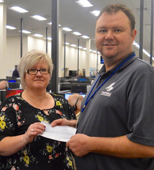 Servicom call centre manager Todd Riley, left, is pictured above with employee Susan Tucker.
