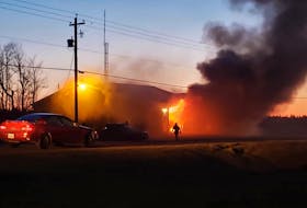 Flames come out of the front of the Shinimicas Fire Department during a fire there on Thursday night. Darren Fisher photo