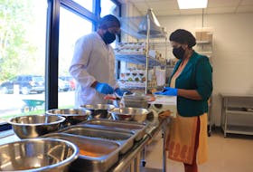 Shivani's Kitchen founder Shivani Dhamija, right, and husband Abhishek Asthana package ready-to-use spices at the Shivani's Kitchen production plant in Windsor on Oct. 23, 2020.  The company's spices are sold at Sobeys and other retail stores in Nova Scotia.