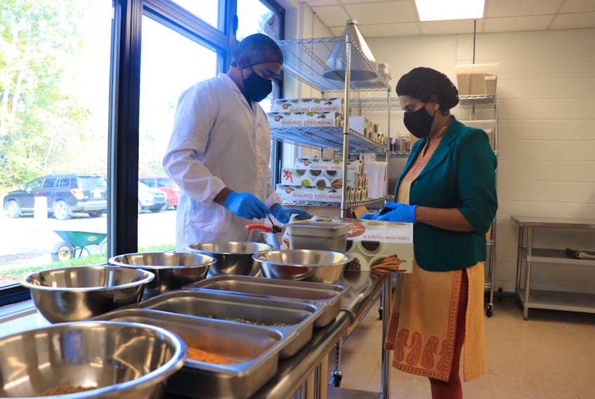 Shivani's Kitchen founder Shivani Dhamija, right, and husband Abhishek Asthana package ready-to-use spices at the Shivani's Kitchen production plant in Windsor on Oct. 23, 2020.  The company's spices are sold at Sobeys and other retail stores in Nova Scotia.