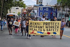 Demonstrators march in a Fight for $15 and Fairness rally on Labour Day, 2020. - Tim Krochak
