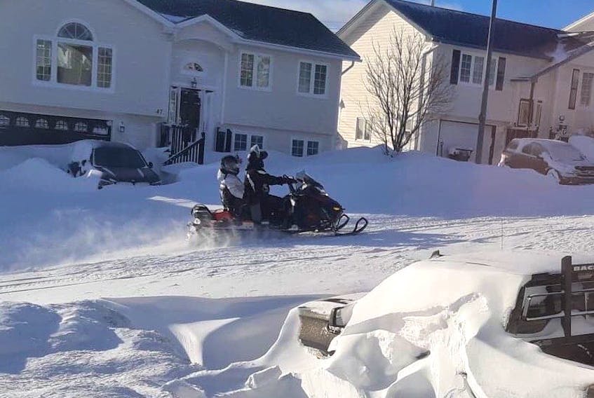 Many residents in the St. John's metro area are taking to the streets during this statement of emergency on snowmobiles, as these riders in Paradise did Saturday, but police are urging people not to do that, as municipalities try to clean up from record-breaking snowfalls.