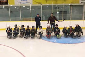 SMECA Grade 7 students ready to learn about and enjoy sledge hockey from Bulldogs sledge hockey program instructors.