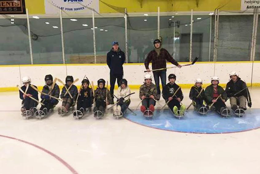 SMECA Grade 7 students ready to learn about and enjoy sledge hockey from Bulldogs sledge hockey program instructors.
