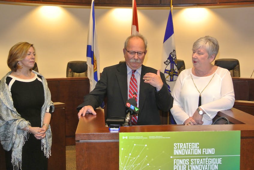 Amherst Mayor David Kogon answers a question while Nova Scotia Power CEO Karen Hutt (left) and federal Rural Economic Development Minister Bernadette Jordan look on during the announcement of a $93-million clean energy project in Amherst on Thursday.