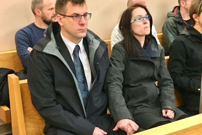 RNC Const. Joe Smyth holds hands with his wife prior to the start of proceedings in his sentencing hearing at provincial court in St. John’s Thursday morning.