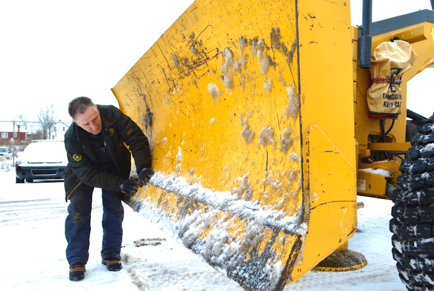 Brent Crocker, truck and transport maintenance worker with the Cape Breton Regional Municipality, checks the edge of the bull blade on a grader at the public works site in Central Division in Sydney, to ensure there’s enough of a cutting edge for the snow and ice on the pavement,  part of the everyday maintenance. The Cape Breton Regional Police say people are not adhering to winter parking regulations and are impeding snow removal in the process. Vehicles not adhering to the parking ban will be ticketed and those obstructing snow removals will be ticketed and towed. Sharon Montgomery-Dupe/Cape Breton Post