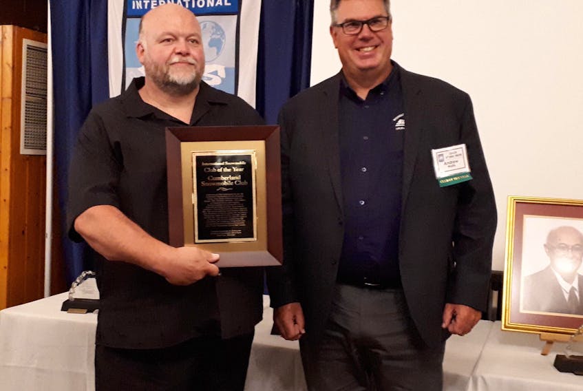 Greg Morash (left) and Andrew Wallis of the Cumberland Snowmobile Club show the International Snowmobile Club of the Year Award they accepted at the International Snowmobile Hall of Fame induction ceremony in Wisconsin on Sept. 22.