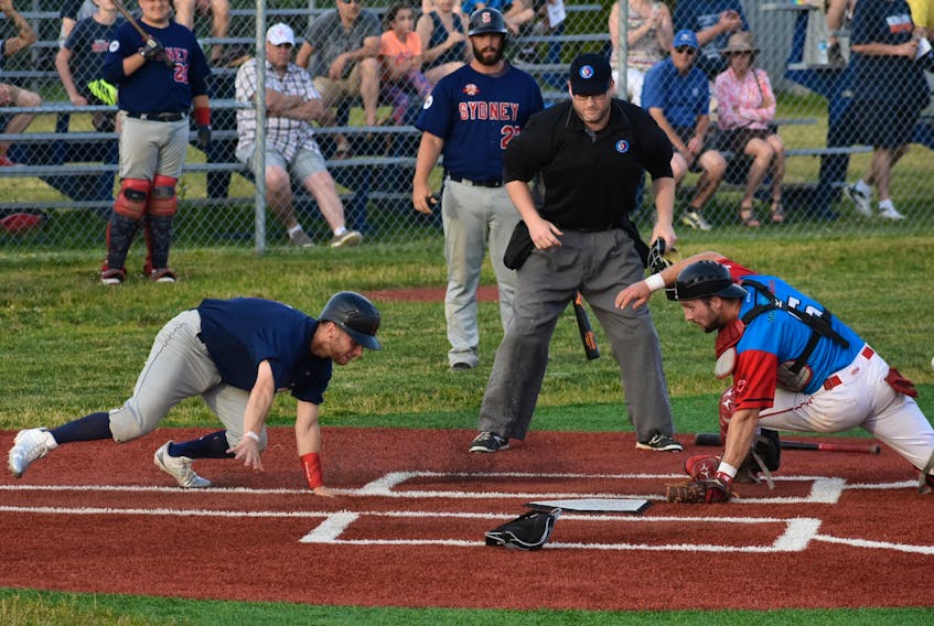 Chris Farrow, left, of the Sydney Sooners scrambles to get home after missing the plate as catcher Greg MacKinnon, right, of the Halifax Pelham Molson Canadians looks for the overthrown ball during Nova Scotia Senior Baseball League action at the Susan McEachern Memorial Ball Park in Sydney on Friday. Farrow would later score, capping off a five-run first inning for the Sooners.