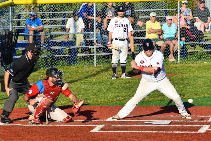 Sydney Sooners' Sean Ferguson keeps an eye on the ball while teammate Phil Brown looks on during a recent play-off game in the Nova Scotia Senior Baseball League. The defending league champion Sooners are taking on regular season winners Dartmouth Moosehead Dry in Game 7 of the league's championship series.