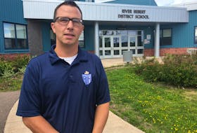 Dan Spence stands in front of the River Hebert District School. The principal said the school is ready to accept students on Tuesday for the new school year, nearly six months after schools were closed suddenly due to the growing global pandemic.