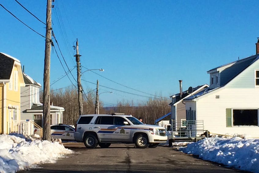 Police block Beaton’s Lane in front of a home where two people were found dead following a house fire on Tuesday.