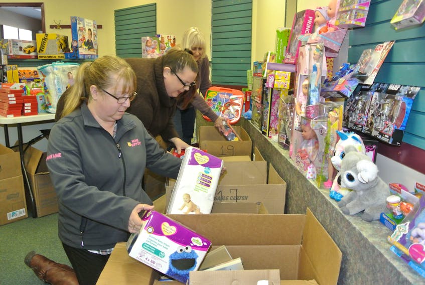 The Springhill Lions Club will help more than 100 children through its Toys for Tots Program that aims to make sure every child in the Springhill area has a present on Christmas morning. Lions (from left) Jeanie Maie Smith, Karen Morris and Wendy Nelson stock boxes with some of the toys that have been collected for this year’s program.
