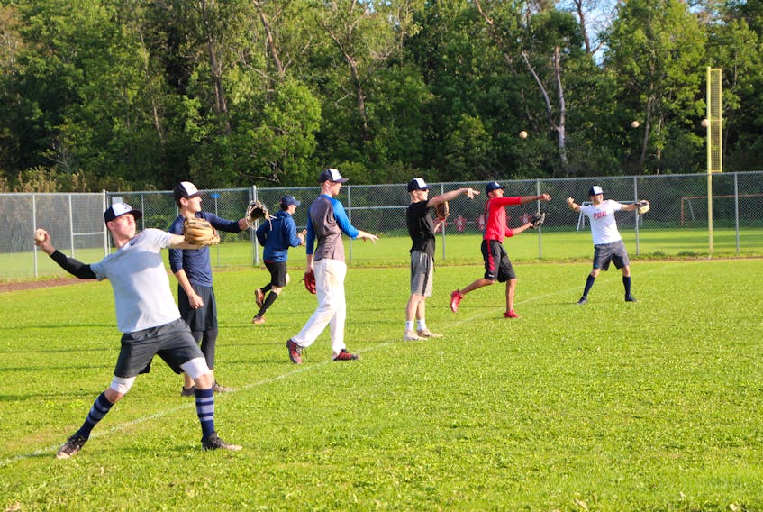Members of the St. F.X. baseball team warm-up their arms prior to the start of a practice Sept. 17.