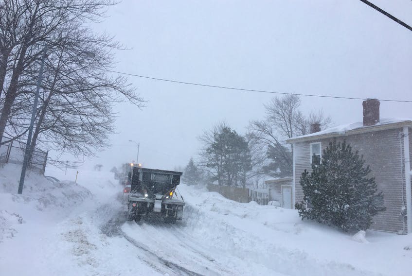 Plows cut around Buckmaster’s Circle in St. John’s Friday after a state of emergency was declared in metro.