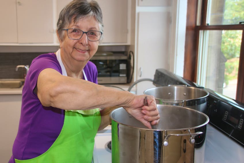 Rev. Dorothy Tay stirs the soup for one of the lunches at St. John’s Anglican Church. This is the 11th year the program has been running.