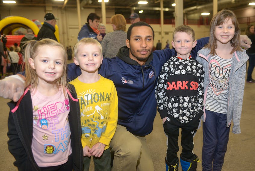 Island Storm forward Trenity Burdine meets siblings, from left, Allie, Blake, Cooper and Skylar Fairhurst during the team’s family-friendly tailgate party Sunday afternoon. The team partnered with the City of Charlottetown to organize the indoors New Year’s Eve celebration after the cancellation of an outdoor party and fireworks due to the chilly temperatures.