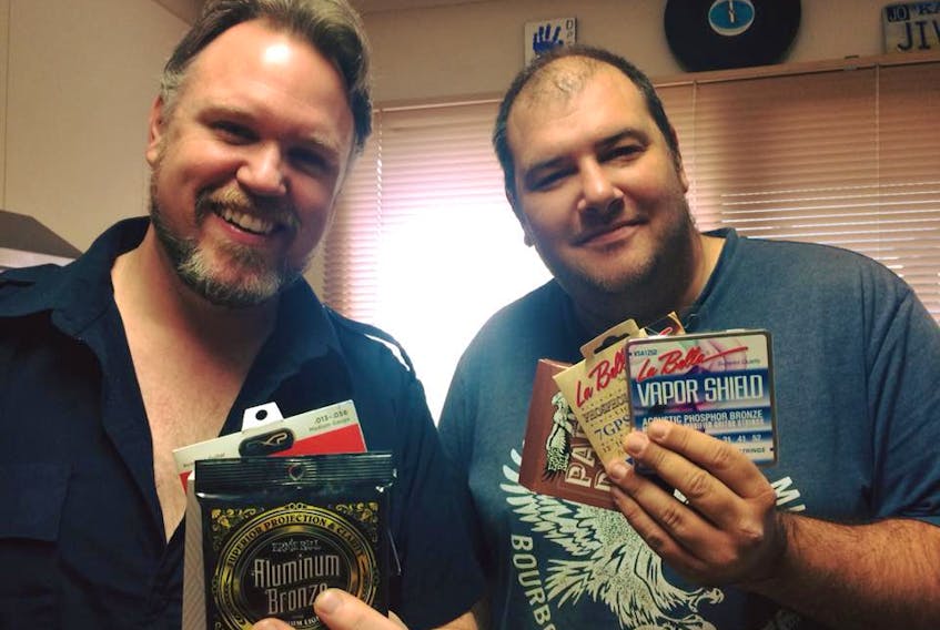 While on tour in Australia, Charlie A’Court, left, was presented with some strings by Aussie blues musician Lloyd Spiegel.