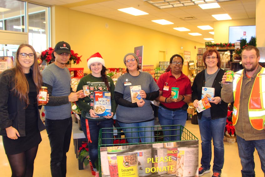 Atlantic Superstore Antigonish dietician Ellen Green (left) is joined by staff members Joan Ortega, Kayla Gillis, Stacy McCafferty, Theresa Borden, Ann Peters and Phillip Connors in a photo to promote the in-store Holiday Food Drive going on now until Dec. 24.