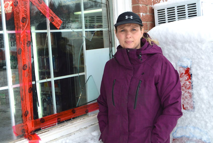 Noelle Christie, owner of Noelle’s Country Market and Bakery in Balls Creek, stands by the front window to her store smashed by a culprit attempting to break in at about 6:25 a.m. Friday. Christie landed at the store only minutes after the suspect – caught on her security video with an axe – had fled the scene. The Cape Breton Regional Police say they are investigating three attempted break-ins to businesses Friday morning within a 40-minute period. Sharon Montgomery-Dupe/Cape Breton Post