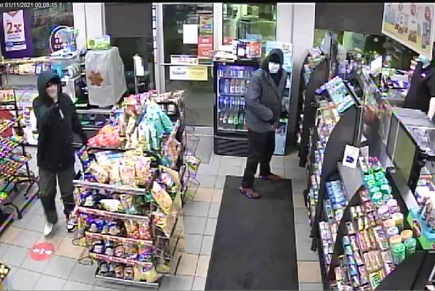 This still taken from security camera video shows the two suspects in an armed robbery at a St. John's service station Monday.
