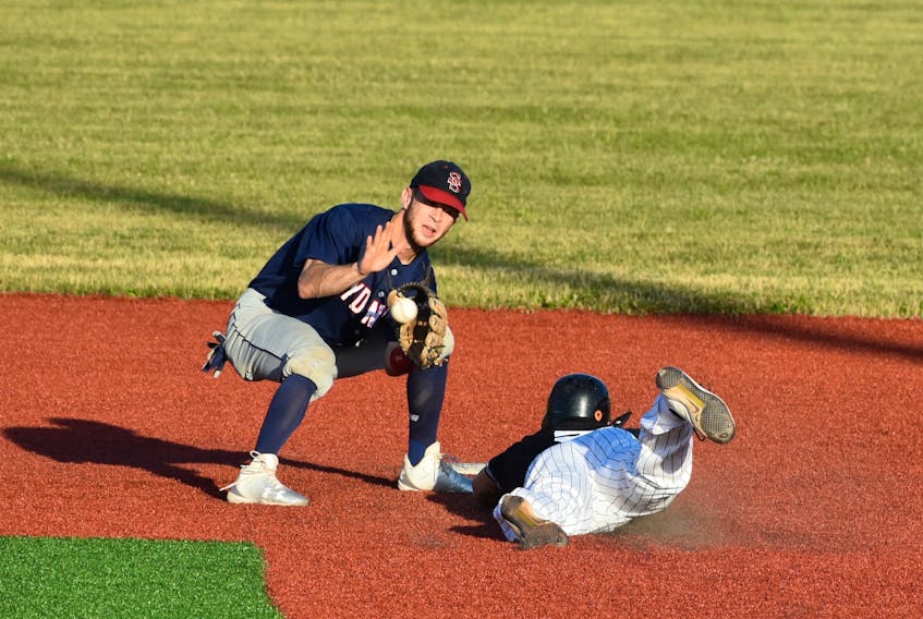 Chris Farrow, left, of the Sydney Sooners prepares to slap a tag on Chris Thibideau of the Dartmouth Moosehead Dry as he tries to steal second base. Thibideau would later be called out on the play. The Moosehead Dry won the game 6-1.