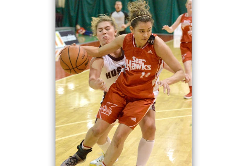 The Memorial Sea-Hawks’ Sydney Stewart drives to the net as Jada Yeo of the Saint Mary’s Huskies chases her down during AUS women’s basketball action at the MUN Field House Sunday afternoon. Stewart had 41 points overall — including 22 Sunday — as Memorial swept a pair of weekend games from visiting Saint Mary’s