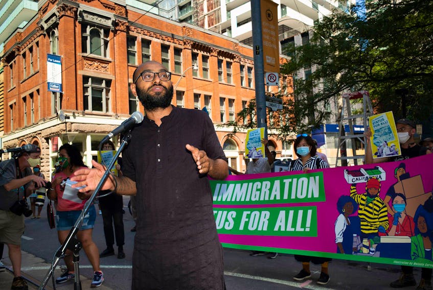 Syed Hussan, a coordinator for the Migrant Workers Alliance for Change, is pictured at an Aug. 23 Toronto rally calling for full and permanent immigration status for all people in Canada.